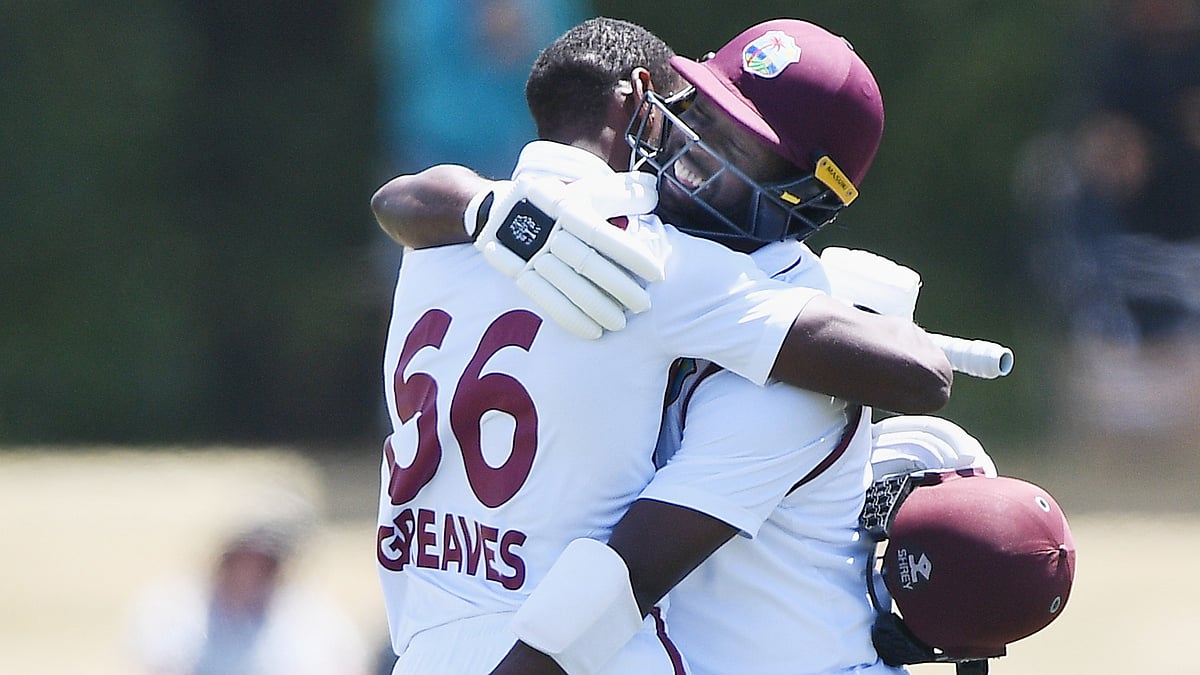 West Indies' Justin Greaves, left, celebrates with teammate Kemar Roach after making 100 runs against New Zealand on Day 5. - AP/Chris Symes                    