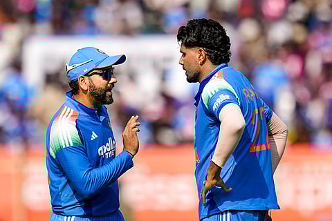India's Rohit Sharma and Harshit Rana interact during the third ODI cricket match of a series between India and South Africa, at ACA-VDCA Cricket Stadium, in Visakhapatnam, Andhra Pradesh.
