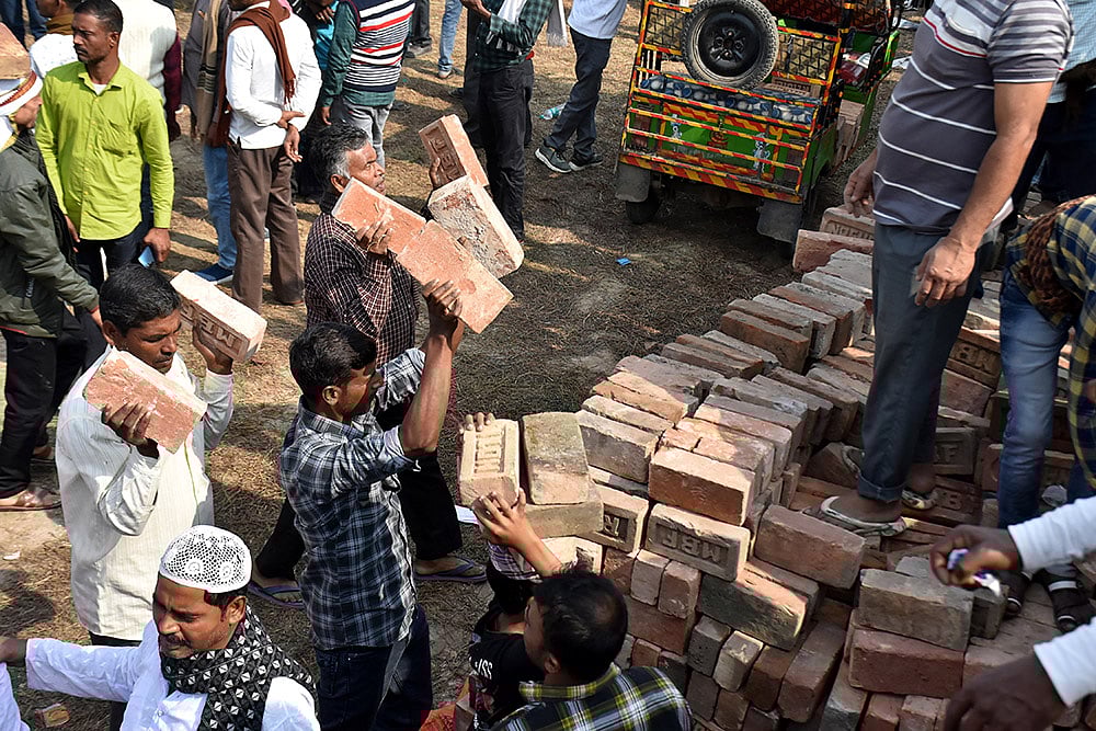 People carry bricks in view of former TMC MLA Humayun Kabir's plan to lay the foundation stone for a mosque, modelled on Ayodhya’s Babri Masjid, at Rejinagar in West Bengal’s Murshidabad district, escalating political temperatures in the state. - | Photo: PTI
