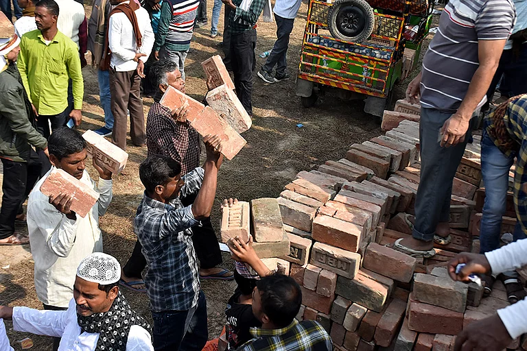 People carry bricks in view of former TMC MLA Humayun Kabir's plan to lay the foundation stone for a mosque, modelled on Ayodhya’s Babri Masjid, at Rejinagar in West Bengal’s Murshidabad district, escalating political temperatures in the state. - | Photo: PTI