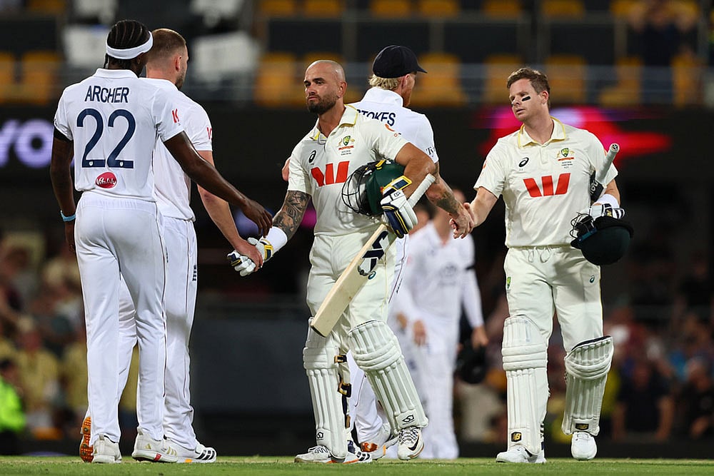 Australia's Jake Weatherald, front, and Australia's captain Steve Smith shake hands with England's players after winning the second Ashes cricket test match between Australia and England in Brisbane. - | Photo: AP/Tertius Pickard