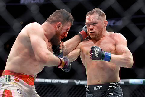 Petr Yan, right, battles with UFC bantamweight champion Merab Dvalishvili during the UFC 323 match  in Las Vegas.
