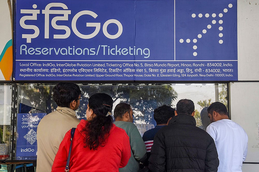 Passengers enquire at an IndiGo airlines counter amid flight disruptions, at Birsa Munda Airport, in Ranchi. - | Photo: PTI