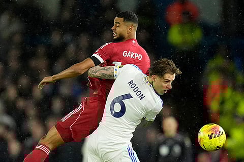 Liverpool's Cody Gakpo and Leeds United's Joe Rodon, front, during the English Premier League soccer match between Leeds United and Liverpool in Leeds, England.
