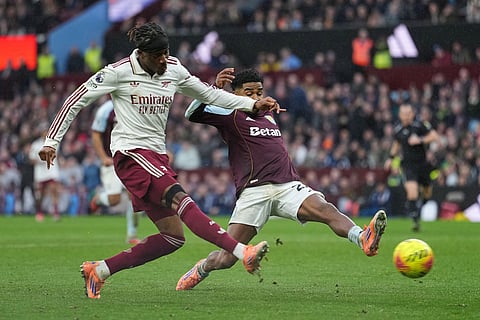 Aston Villa's Ian Maatsen, right, challenges for the ball with Arsenal's Noni Madueke during the English Premier League soccer match between Aston Villa and Arsenal in Birmingham, England.