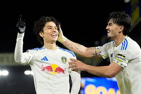 Leeds United's Ao Tanaka celebrates scoring during the English Premier League soccer match between Leeds United and Liverpool in Leeds, England.