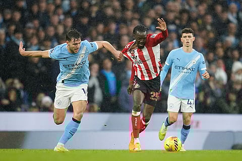 Manchester City's Nico Gonzalez, left, challenges for the ball with Sunderland's Bertrand Traore during the English Premier League soccer match between Manchester City and Sunderland in Manchester, England.
