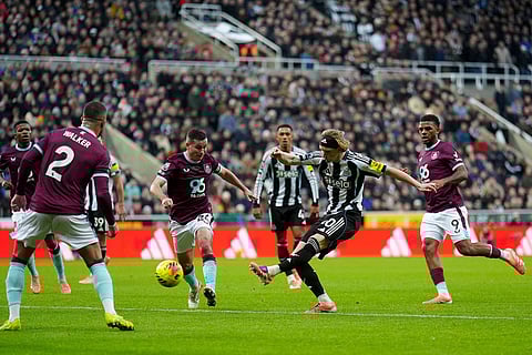 Newcastle United's Anthony Gordon, centre, shoots the ball during the English Premier League soccer match between Newcastle United and Burnley in Newcastle upon Tyne, England.