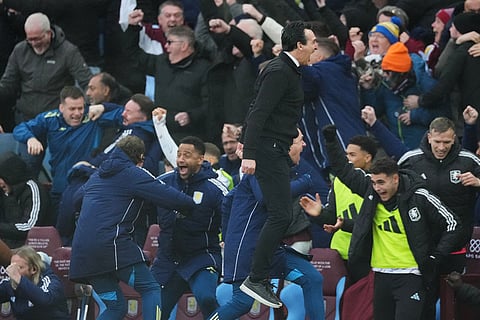 Aston Villa's head coach Unai Emery, centre, celebrate with his staff after Aston Villa's Emiliano Buendia scored his side's second goal during the English Premier League soccer match between Aston Villa and Arsenal in Birmingham, England.