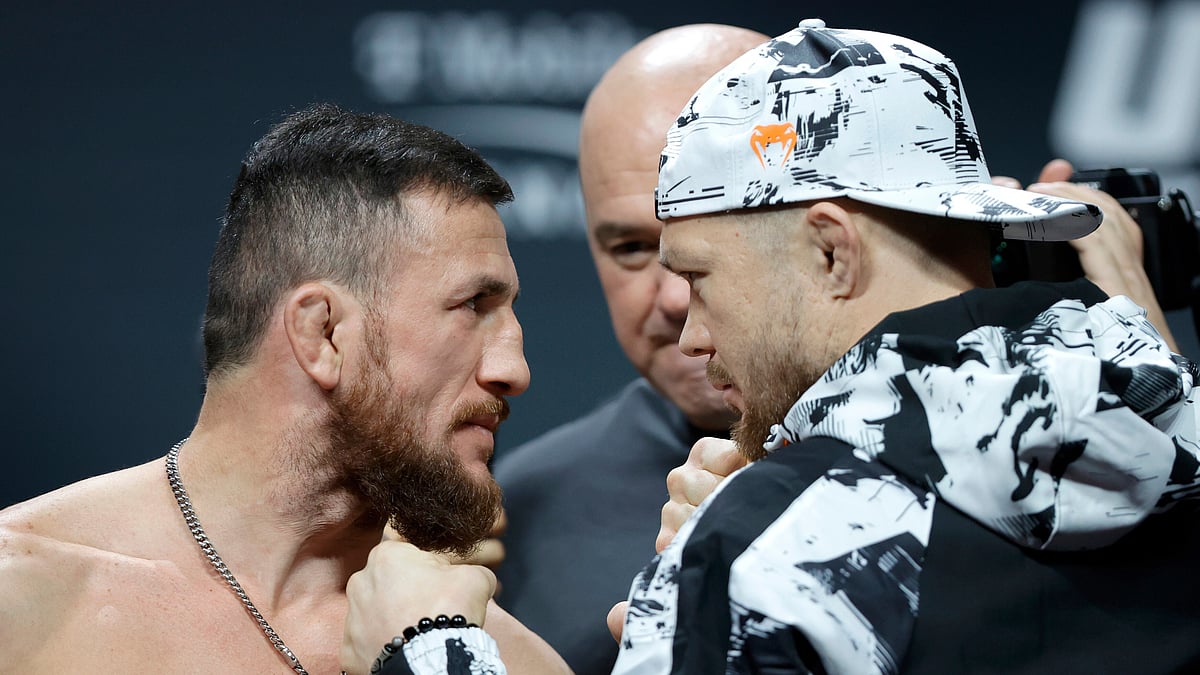 UFC bantamweight champion Merab Dvalishvili, left, of Georgia, and Petr Yan, of Russia, face off during a ceremonial weigh-in. - Steve Marcus/Las Vegas Sun via AP