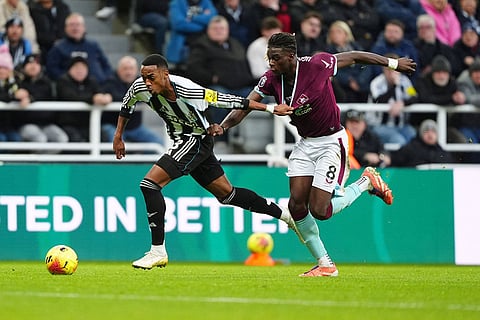 Newcastle United's Joe Willock, left, and Burnley's Lesley Ugochukwu battle for the ball  during the English Premier League soccer match between Newcastle United and Burnley in Newcastle upon Tyne, England.
