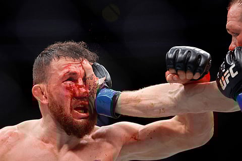 UFC bantamweight champion Merab Dvalishvili, left, fights against Petr Yan during the UFC 323 match in Las Vegas.