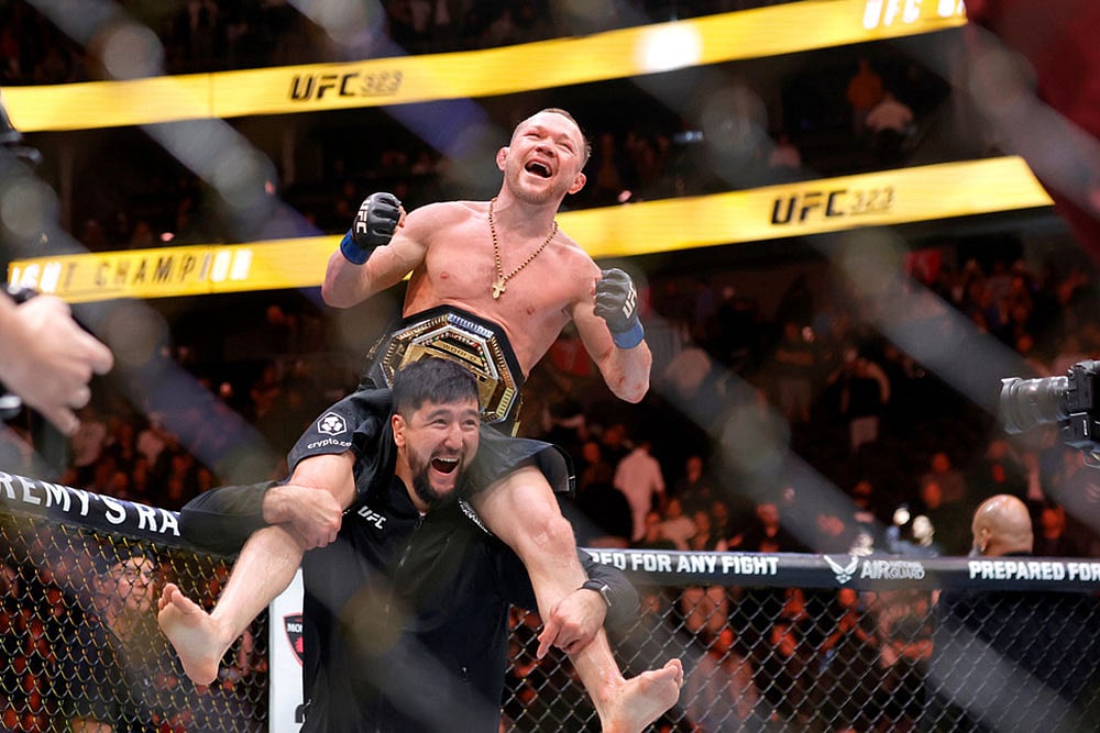 Petr Yan celebrates with a member of his team after defeating UFC bantamweight champion Merab Dvalishvili during UFC 323 in Las Vegas. - | Photo: Steve Marcus/Las Vegas Sun via AP