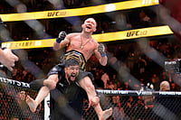 | Photo: Steve Marcus/Las Vegas Sun via AP : Petr Yan celebrates with a member of his team after defeating UFC bantamweight champion Merab Dvalishvili during UFC 323 in Las Vegas.
