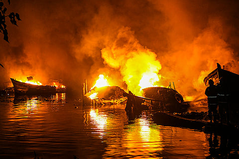 Smoke and flames billow after fishing boats caught fire, at Ashtamudi Lake in Kollam, Kerala. Around 10 boats, anchored at the lake, were gutted in the incident. 