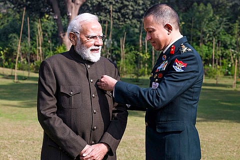 In this image posted on Dec. 7, 2025, Prime Minister Narendra Modi receives a badge on the occasion of the Armed Forces Flag Day. 