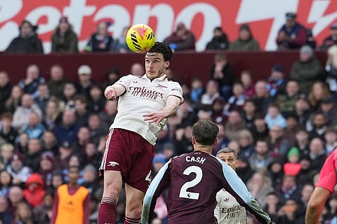 Arsenal's Declan Rice heads the ball during the English Premier League soccer match between Aston Villa and Arsenal in Birmingham, England.