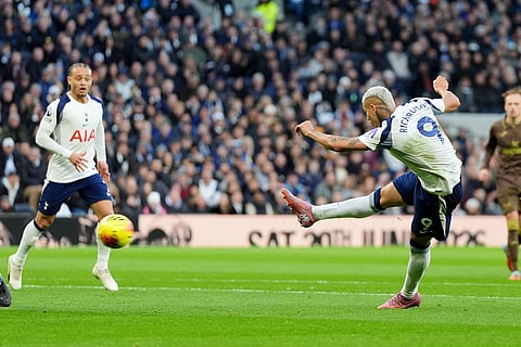 Tottenham Hotspur's Richarlison, right, shoots the ball during the English Premier League soccer match between Tottenham Hotspur and Brentford in London.