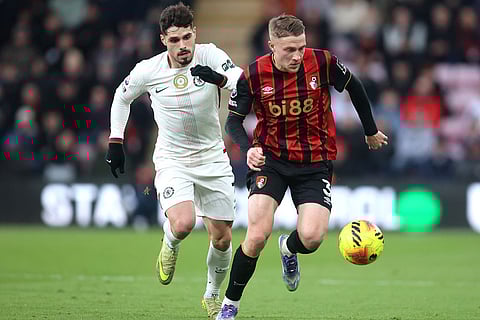 Chelsea's Pedro Neto, left, and Bournemouth's Adrien Truffert in action during the English Premier League soccer match between Bournemouth and Chelsea in Bournemouth, England.