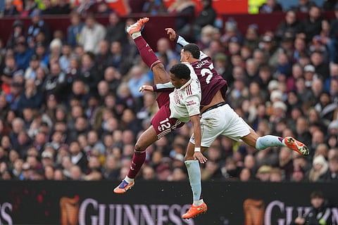 Aston Villa's Morgan Rogers, right, challenges for the ball with Arsenal's Jurrien Timber during the English Premier League soccer match between Aston Villa and Arsenal in Birmingham, England.