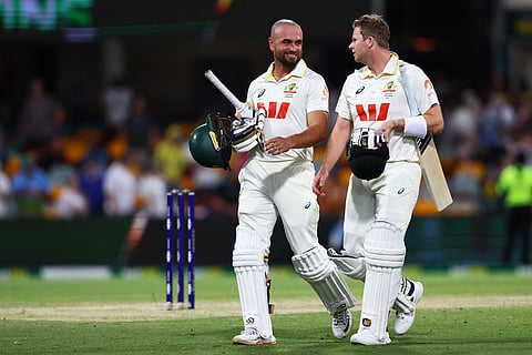 Australia's Jake Weatherald, left, and Australia's captain Steve Smith walk off the field after winning the second Ashes cricket test match between Australia and England in Brisbane.