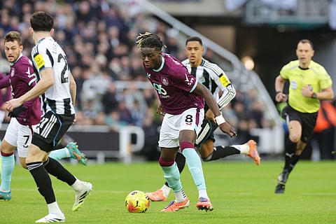 Burnley's Lesley Ugochukwu, centre, controls the ball during the English Premier League soccer match between Newcastle United and Burnley in Newcastle upon Tyne, England.