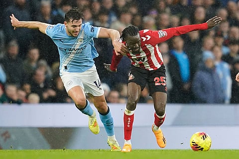 Manchester City's Nico Gonzalez, left, challenges for the ball with Sunderland's Bertrand Traore during the English Premier League soccer match between Manchester City and Sunderland in Manchester, England.