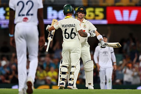 Australia's Jake Weatherald and Australia's captain Steve Smith celebrate after winning the second Ashes cricket test match between Australia and England in Brisbane.