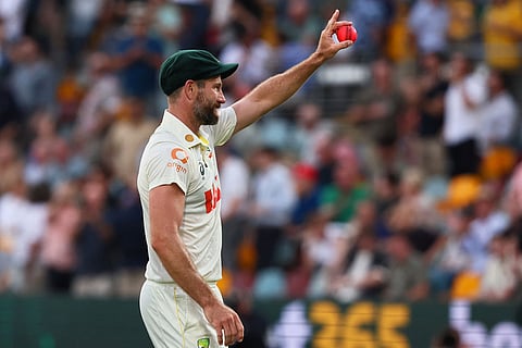Australia's Michael Neser shows the ball after getting five wickets during the second Ashes cricket test match between Australia and England in Brisbane, Sunday, Dec. 7, 2025.. ()