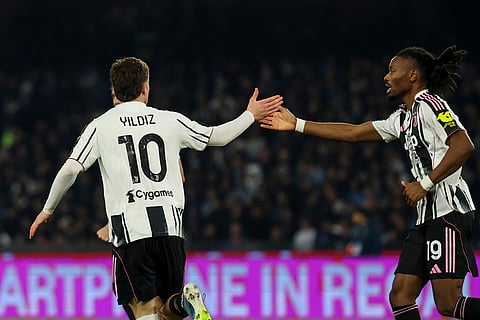 Juventus' Kenan Yildiz, left, celebrates after scoring his side's first goal during the Serie A soccer match between Napoli and Juventus, in Naples, Italy.