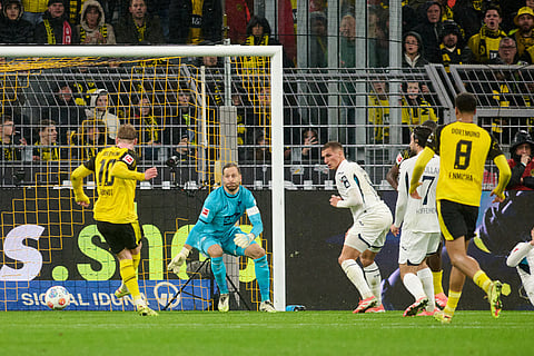 Borussia's Julian Brandt, left, scores the opening goal during Germany Bundesliga soccer match between Borussia Dortmund and TSG 1899 Hoffenheim, in Dortmund, Germany.