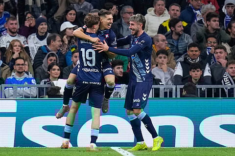 Celta's Williot Swedberg celebrates with teammates after he scored the opening goal during the Spanish La Liga soccer match between Real Madrid and Celta Vigo in Madrid, Spain.