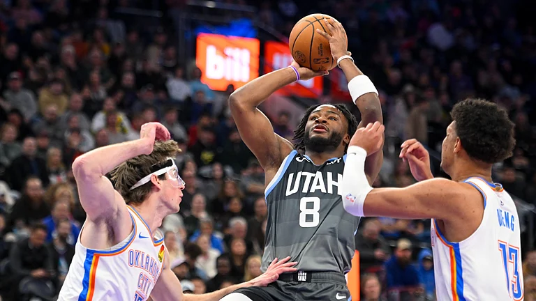 Isaiah Collier #8 of the Utah Jazz shoots over Branden Carlson #15 of the Oklahoma City Thunder during the first half of a game at Delta Center on December 07, 2025 in Salt Lake City, Utah. - null