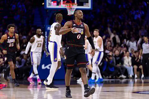 Philadelphia 76ers' Tyrese Maxey, center, reacts to his three-point shot during the first half of an NBA basketball game against the Los Angeles Lakers in Philadelphia.