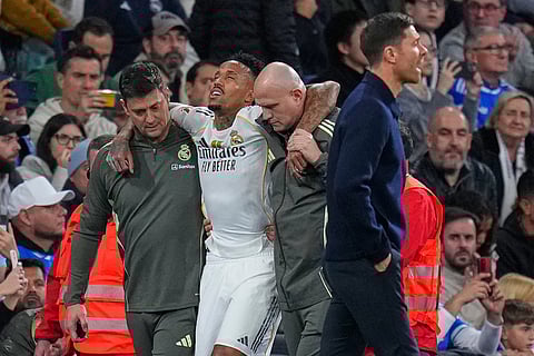 Real Madrid's Eder Militao is assisted from the pitch after getting an injury during the Spanish La Liga soccer match between Real Madrid and Celta Vigo in Madrid, Spain.