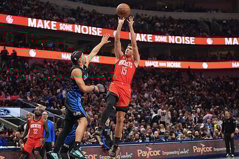 Houston Rockets guard Reed Sheppard (15) shoots against Dallas Mavericks guard Ryan Nembhard during the first half of an NBA basketball game in Dallas.
