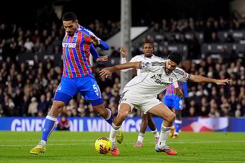 Crystal Palace's Maxence Lacroix, left, and Fulham's Raul Jimenez battle for the ball during the English Premier League soccer match between Fulham and Crystal Palace, in London.
