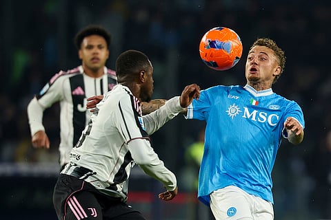 Napoli's Noa Lang, right, challenges for the ball during the Serie A soccer match between Napoli and Juventus, in Naples, Italy.