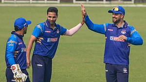 PTI : Uttar Pradesh's Bhuvneshwar Kumar, centre, celebrates with his teammates after taking the wicket.