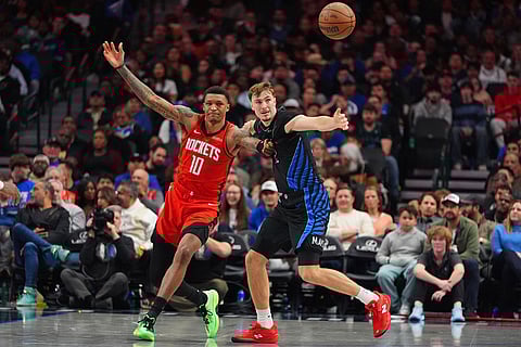 Dallas Mavericks forward Cooper Flagg (32) forces the steal against Houston Rockets forward Jabari Smith Jr. (10) during the second half of an NBA basketball game in Dallas.