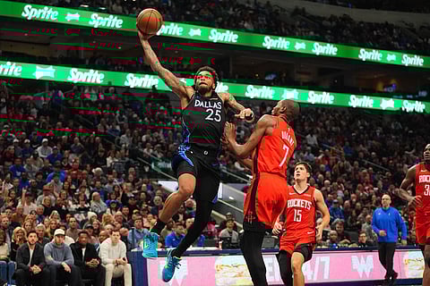 Dallas Mavericks forward P.J. Washington (25) drives past Houston Rockets forward Kevin Durant (7) during the second half of an NBA basketball game in Dallas.