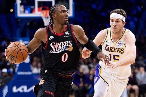 Philadelphia 76ers' Tyrese Maxey, left, drives to the basket against Los Angeles Lakers' Austin Reaves, right, during the second half of an NBA basketball game in Philadelphia.