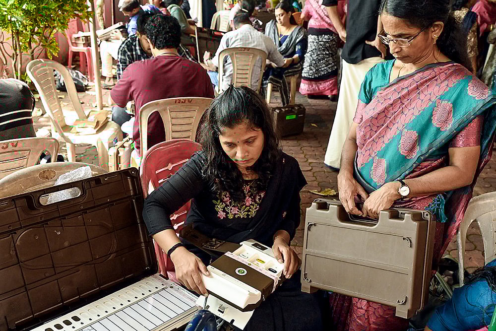 Polling officials check the election materials on the eve of the first phase of Kerala local body polls, at a distribution center in Thiruvananthapuram. - Photo: PTI