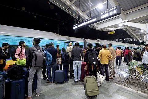 Air passengers impacted by cancellations prepare to board a special train, being run by Indian Railways amid IndiGo flight disruptions, in Ahmedabad.