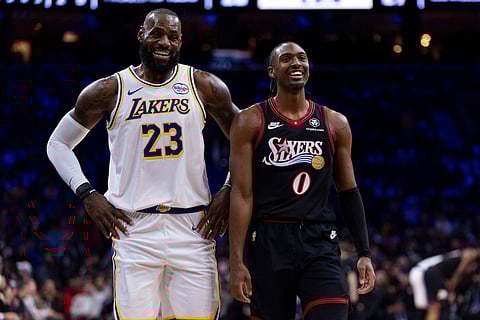 Los Angeles Lakers' LeBron James, left, talks with Philadelphia 76ers' Tyrese Maxey, right, during the first half of an NBA basketball game in Philadelphia.