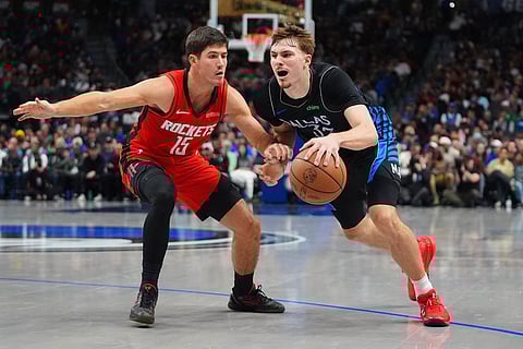 Dallas Mavericks forward Cooper Flagg (32) drives against Houston Rockets guard Reed Sheppard (15) during the second half of an NBA basketball game in Dallas.