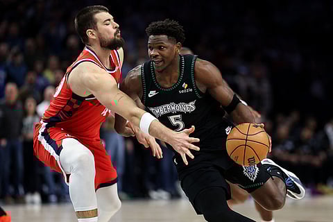 Minnesota Timberwolves guard Anthony Edwards, right, works around Los Angeles Clippers center Ivica Zubac (40) during the first half of an NBA basketball game in Minneapolis. 