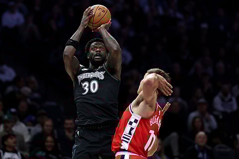 Minnesota Timberwolves forward Julius Randle, left, shoots the ball as Los Angeles Clippers center Brook Lopez (11) defends during the first half of an NBA basketball game in Minneapolis.