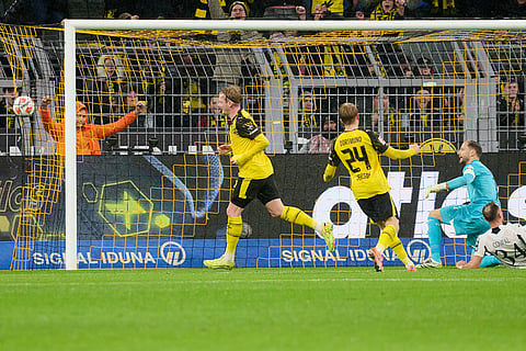 Borussia's Julian Brandt celebrates with teammates after scoring the opening goal during Germany Bundesliga soccer match between Borussia Dortmund and TSG 1899 Hoffenheim, in Dortmund, Germany.