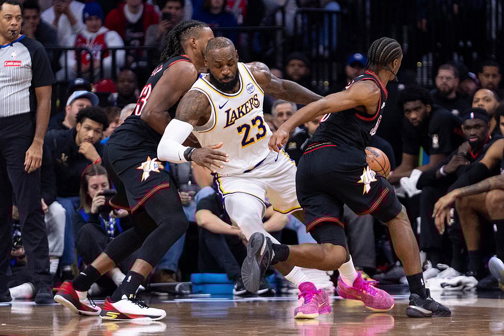 Los Angeles Lakers' LeBron James, center, gets the ball stolen by Philadelphia 76ers' Tyrese Maxey, right, as Jabari Walker, left, is defending during the second half of an NBA basketball game in Philadelphia. - | Photo: AP/Chris Szagola